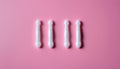 Three toothbrushes against a pink background