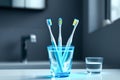 Three toothbrushes are in a glass of water Royalty Free Stock Photo