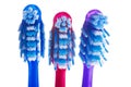 Three toothbrushes on a white background
