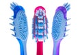 Three toothbrushes on a white background