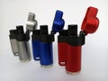 Three torch lighters with the top open arranged on a white background Royalty Free Stock Photo