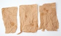 Three torn crumpled pieces of brown paper with grease stains Royalty Free Stock Photo