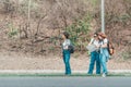 Three tourist looking for a road with map and clock in the forest with backpack