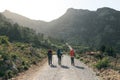 Three tourists with backpacks travel in the mountains