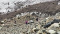 Three tourists descend the kurumnik to the Maili glacier, North Ossetia.