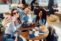 Three tourists makes selfie on phone in airport