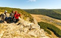 Three tourists are sitting on top of the Ukla Kaya mountain.