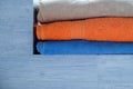 Three towels of different colors are on the blue shelf Royalty Free Stock Photo