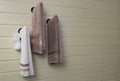 Three towels are hanging on the wall in the bathroom Royalty Free Stock Photo
