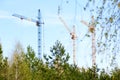 Three tower cranes at a construction site Royalty Free Stock Photo