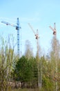 Three tower cranes at a construction site Royalty Free Stock Photo