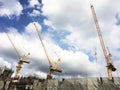 Three Tower cranes are working on construction site. Royalty Free Stock Photo