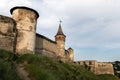 Three towers and stone walls of the medieval fortress of the XVI century in the city of Kamianets-Podilskyi. Royalty Free Stock Photo