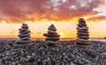 three towewrs or turrets of stone in a nice empty sea beach with coast line guring sunset or sunrise with amazing cloude sky on Royalty Free Stock Photo