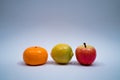 Three toy fruits on light blue background Royalty Free Stock Photo