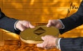 Three traders hands holding large ether or ethereum coin