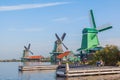 Three traditional dutch windmill beside the canal