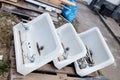 Three traditional old bathroom sinks at house clearing