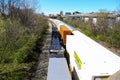 Three trains riding on the railroad tracks surrounded by lush green trees and bare winter trees and clear blue sky in Atlanta