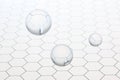 Three transparent balls spheres flying on an honeycomb glass pattern with copy space for your text Royalty Free Stock Photo