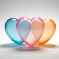 Three transparent glass heart shapes