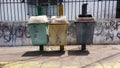 Three trash cans on the pedestrian sidewalk Royalty Free Stock Photo
