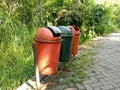 three trash cans by the roadside