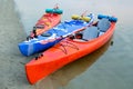 Three Traveling Kayaks on the Sand Beach near Beautiful River or Lake at the Evening. Travel and Adventure Concept.