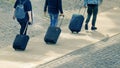 Three traveller tourist carrying their luggage on a pedestrian walkway. Top view and empty copy space Royalty Free Stock Photo