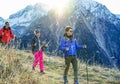 Three trekkers doing excursion on alps top french mountain - Young happy people hiking with back sun light - Sport,healthy