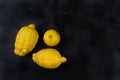 Three trendy organic lemons on a dark background. Horizontal orientation of the image.