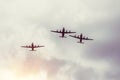 Three turboprop bombers fly in the gray sky