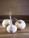 Three turnips on a wooden table