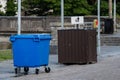 Three type of waste bins in town. Temporary big blue on wheels. Big size permanent decorated bin and small permanent. Waste and