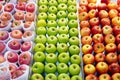 Three types of apples on a supermarket shelf Royalty Free Stock Photo