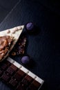Three types of chocolate - black, milk and white with luxury handmade chocolates on a black background with copy space Royalty Free Stock Photo