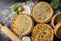 Three types of classic unleavened wheat flatbread with herbs and cheese made from flour, eggs, onions and water.