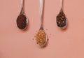 Three types of coffee in spoons in assortment: instant, ground grain and grain Royalty Free Stock Photo