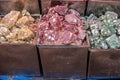 Three types of stones lying in containers at Goa commerce in india. Yellow, red and green rocks sold in street market.