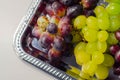 Three types of green, red and black grapes on a silver tray Royalty Free Stock Photo