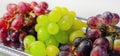 Three types of green, red and black grapes on a silver tray Royalty Free Stock Photo