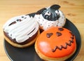 Three Types of Halloween Ghost Doughnuts Isolated on Wooden Background Royalty Free Stock Photo
