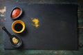 Three types of sauce - tomato sauce, soy sauce and pesto sauce on a stone and wooden background