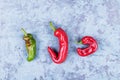 Three ugly red chili peppers on a blue grunge background, minimal style, creative food concept