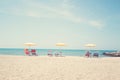 Three Umbrellas and Chairs at sandy beach in Durres, Adriatic Sea shore of Albania