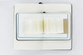 Three unfold notebooks lie on top of each other and fan open small notepad with blank light beige pages. Top view. White back