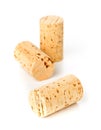 Three unused, new, brown natural wine cork on white