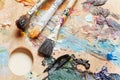 Three used paint brushes on artistic pallette Royalty Free Stock Photo
