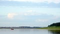 Three vague silhouettes of people of the Northern Yakuts on a boat with oars floating across the river vilyu