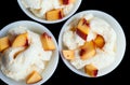 Three vanilla ice-cream with peach isolated on black.